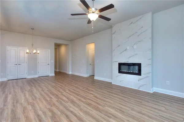 a view of an empty room and window and wooden floor