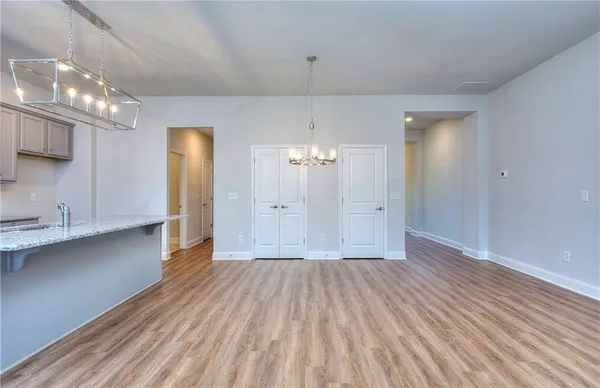 a view of a room with wooden floor and a window