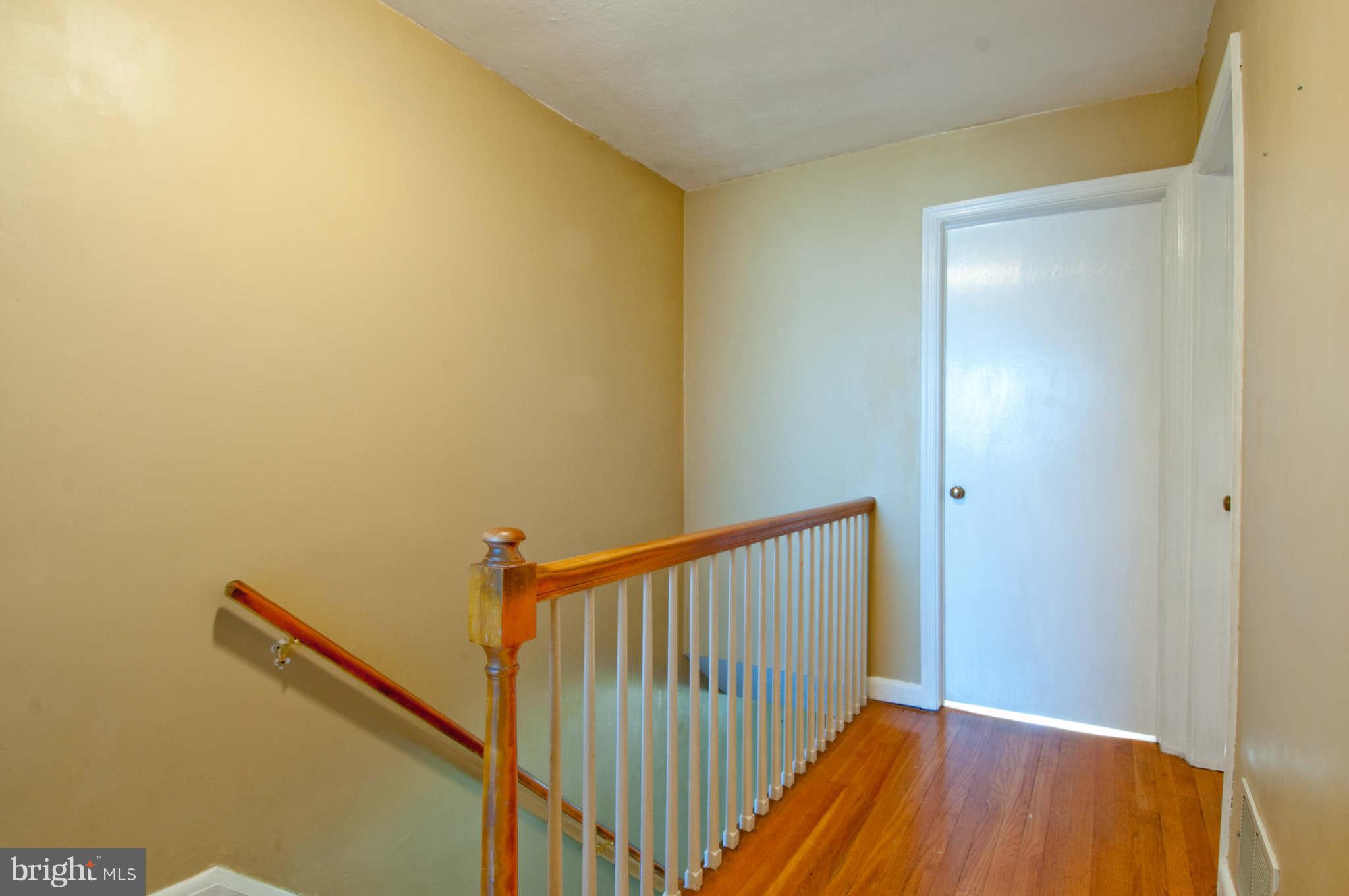 422 Westfield Road Baltimore, MD 21222 - Photo 13 of 24 a view of a hallway with wooden floor