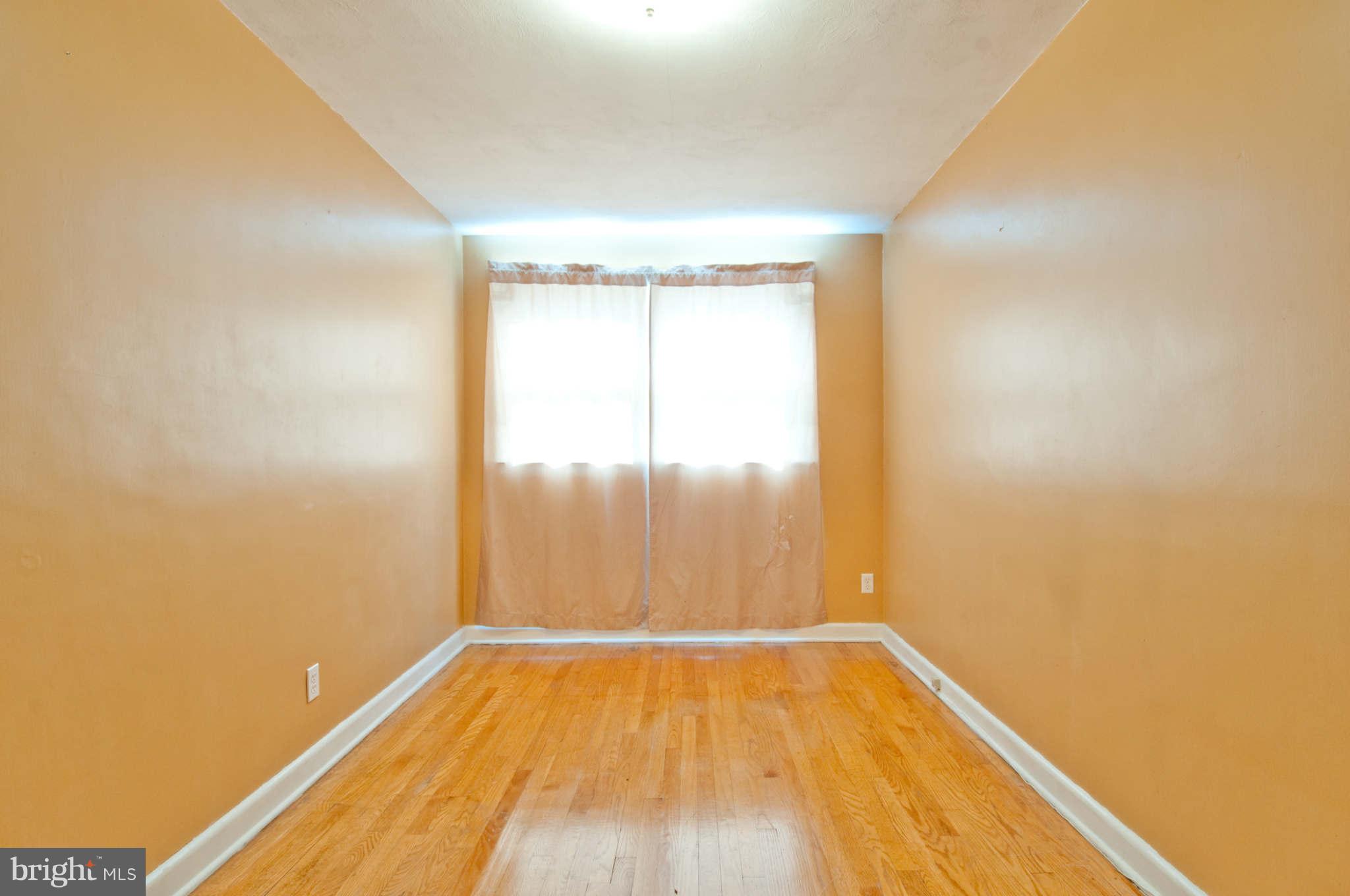 422 Westfield Road Baltimore, MD 21222 - Photo 14 of 24 a view of empty room with wooden floor and fan