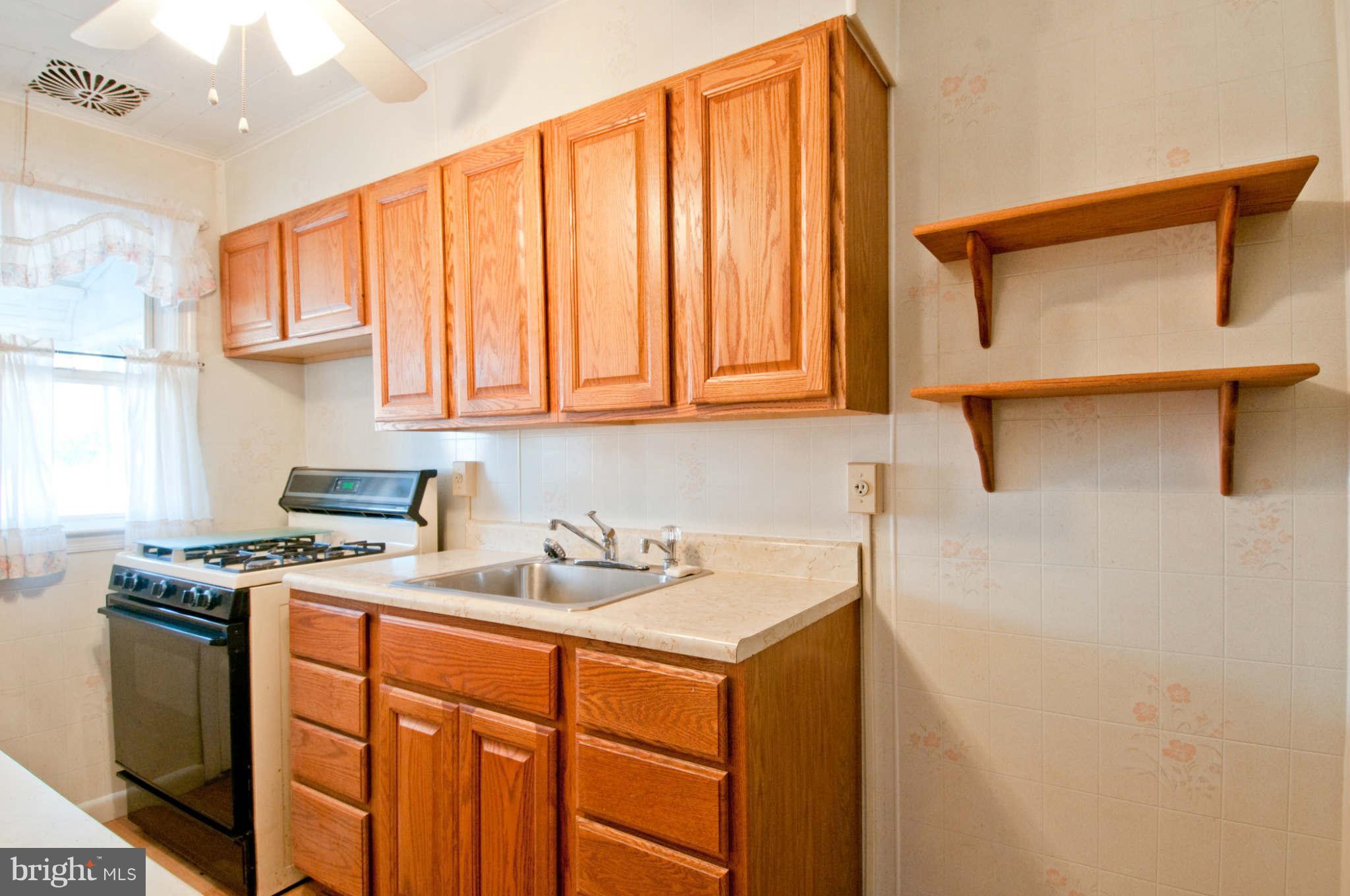 422 Westfield Road Baltimore, MD 21222 - Photo 8 of 24 a kitchen with stainless steel appliances granite countertop a sink stove and cabinets