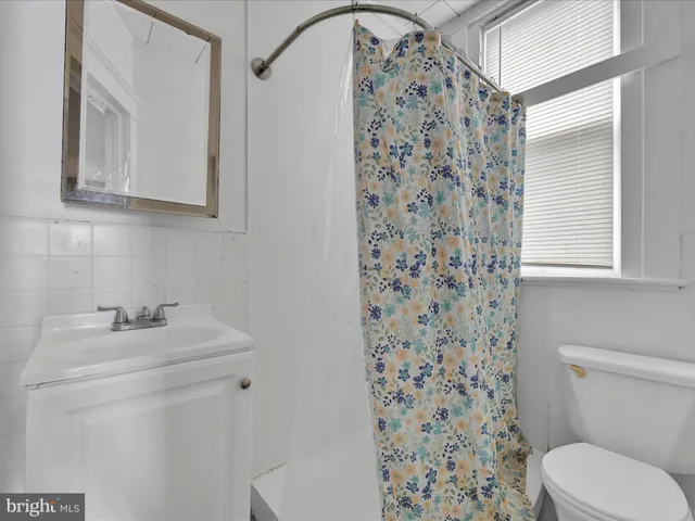 a bathroom with a sink toilet and mirror