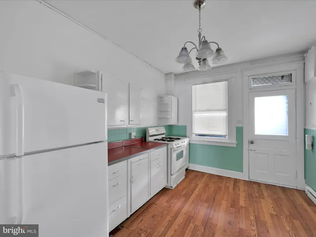 a kitchen with stainless steel appliances granite countertop a refrigerator a sink dishwasher a stove and a refrigerator