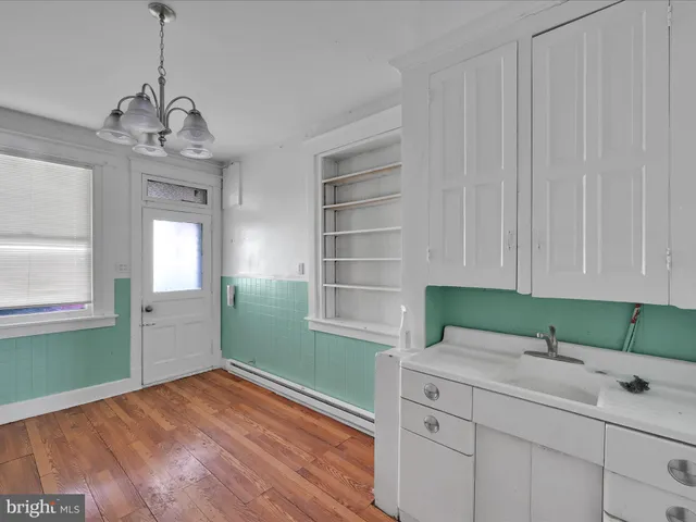 a kitchen with a sink cabinets and window