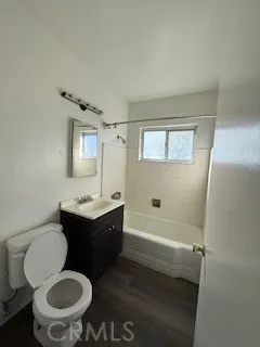a bathroom with a sink toilet mirror and shower