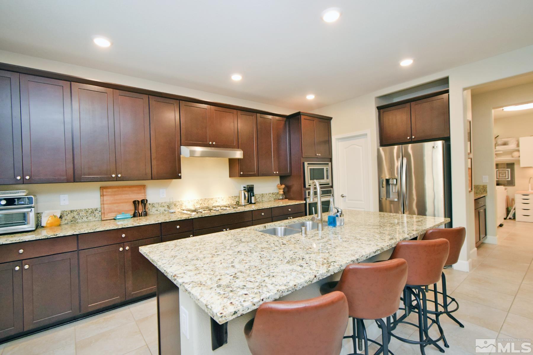1630 Scott Valley Road Reno, NV 89523 - Photo 8 of 33 a kitchen with granite countertop sink cabinets and stainless steel appliances