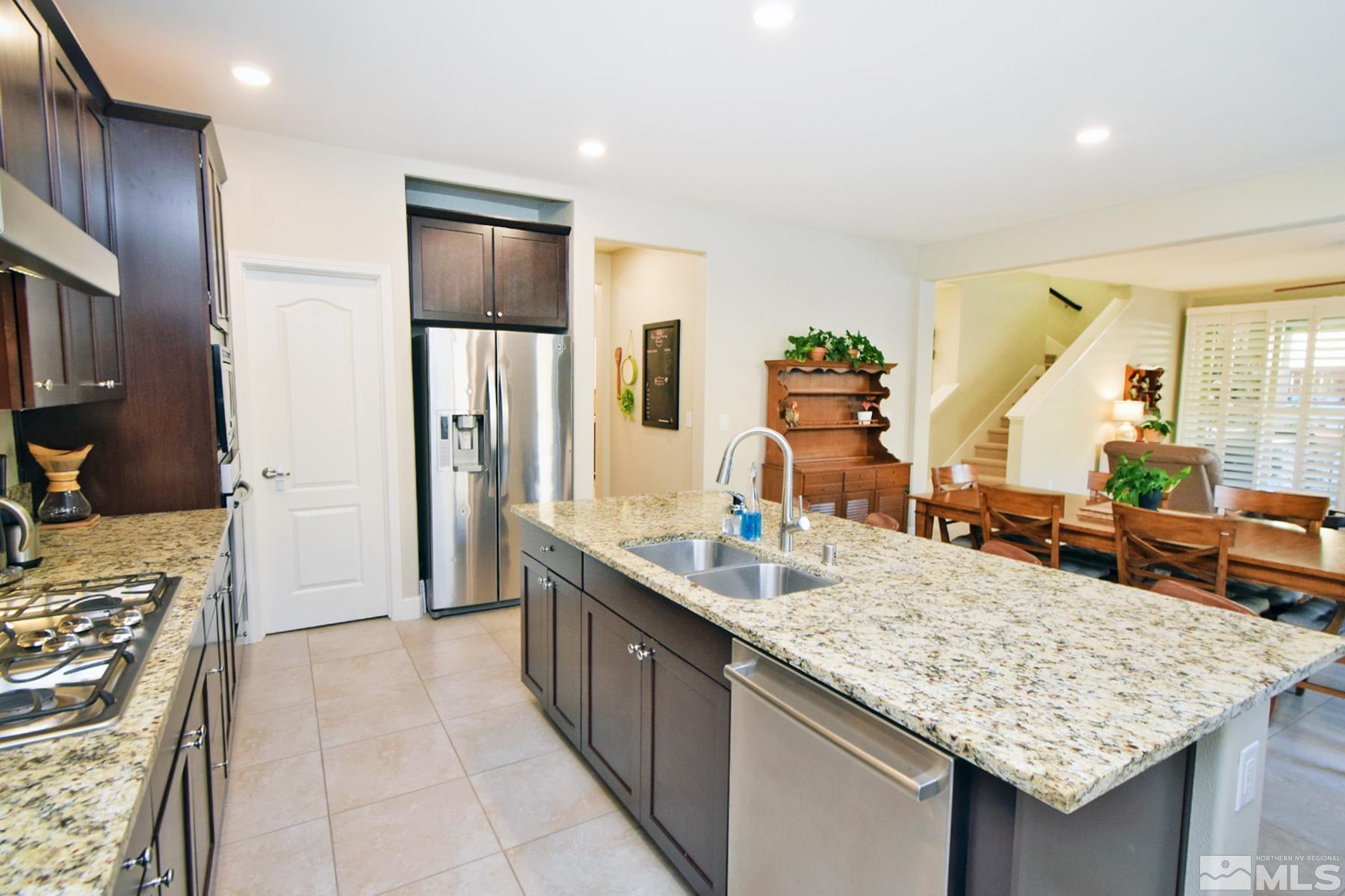 1630 Scott Valley Road Reno, NV 89523 - Photo 9 of 33 a kitchen with kitchen island granite countertop wooden cabinets and a counter top space