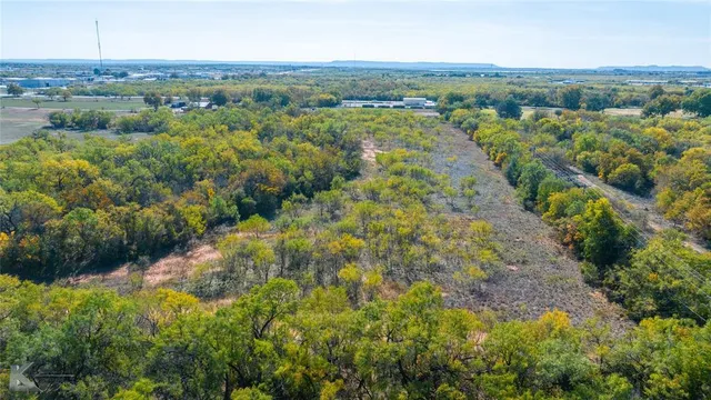 an aerial view of a houses with a yard