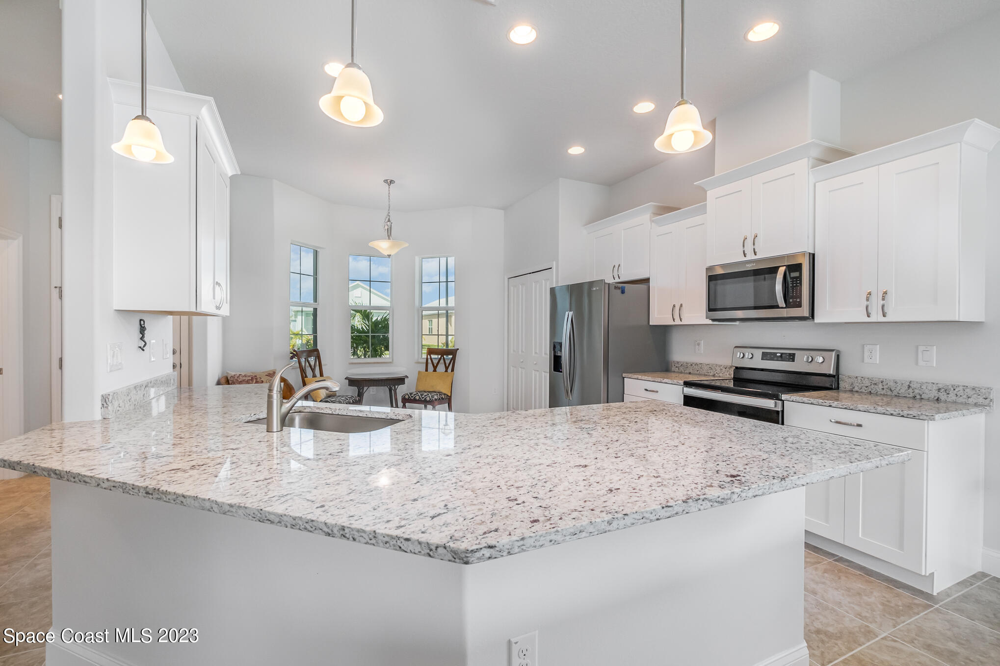 665 Lorelei Avenue Melbourne, FL 32901 - Photo 20 of 32 a kitchen with stainless steel appliances granite countertop a sink refrigerator and microwave