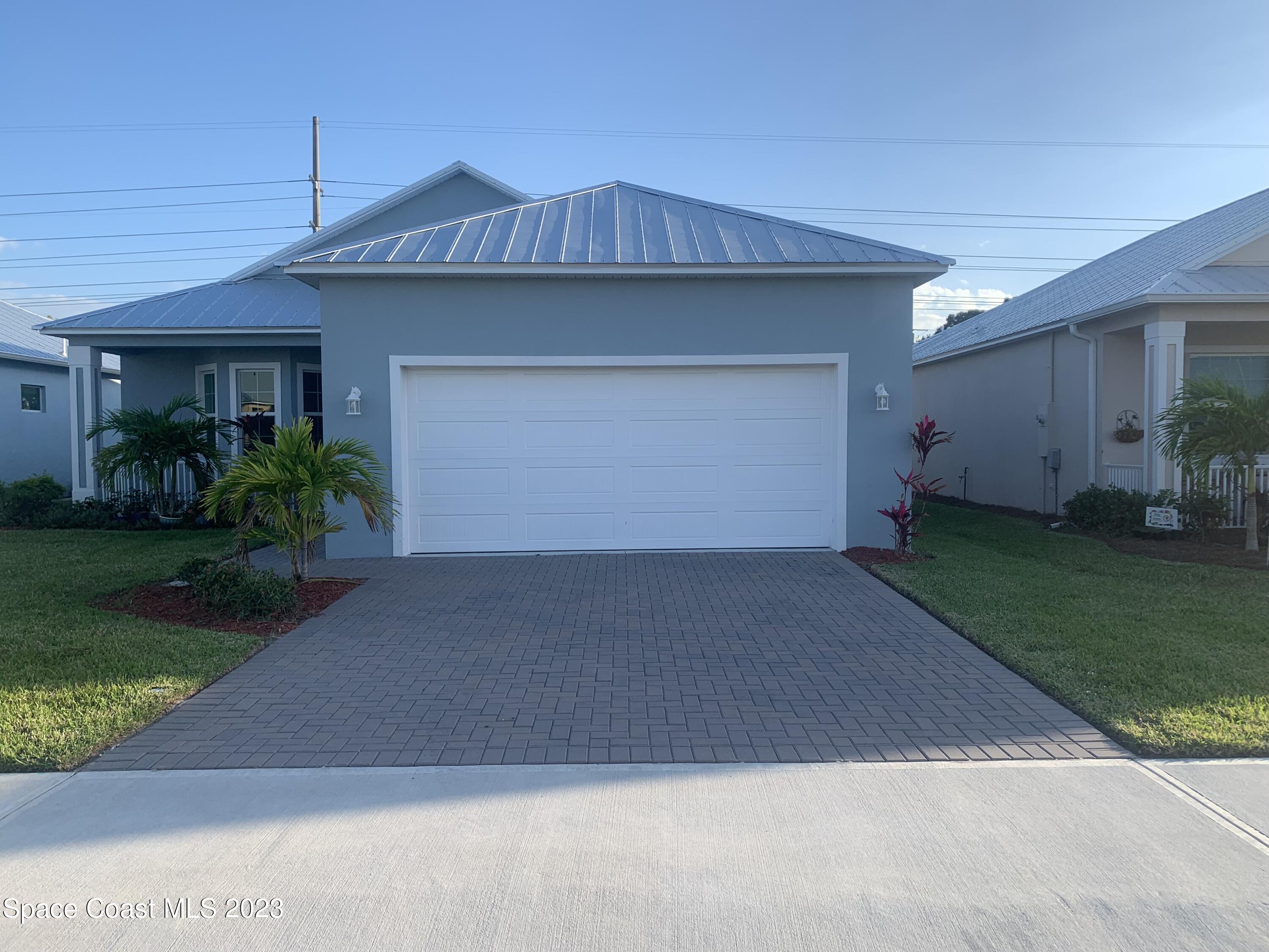 665 Lorelei Avenue Melbourne, FL 32901 - Photo 2 of 32 a front view of a house with a yard and garage
