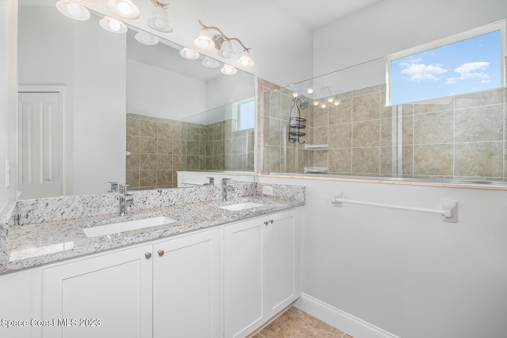 665 Lorelei Avenue Melbourne, FL 32901 - Photo 25 of 32 a bathroom with a sink vanity granite and a mirror