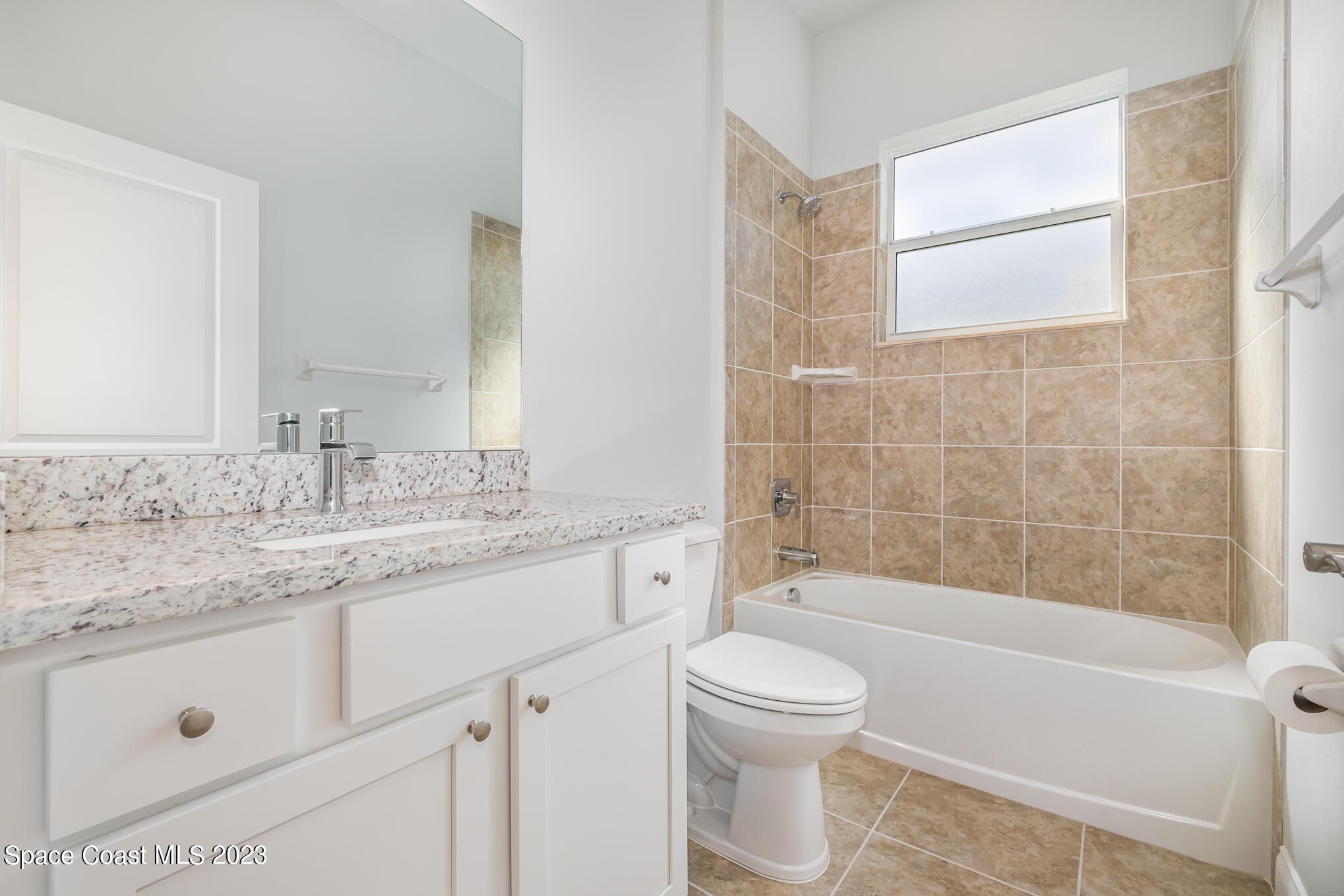 665 Lorelei Avenue Melbourne, FL 32901 - Photo 28 of 32 a bathroom with a granite countertop sink a toilet and bathtub