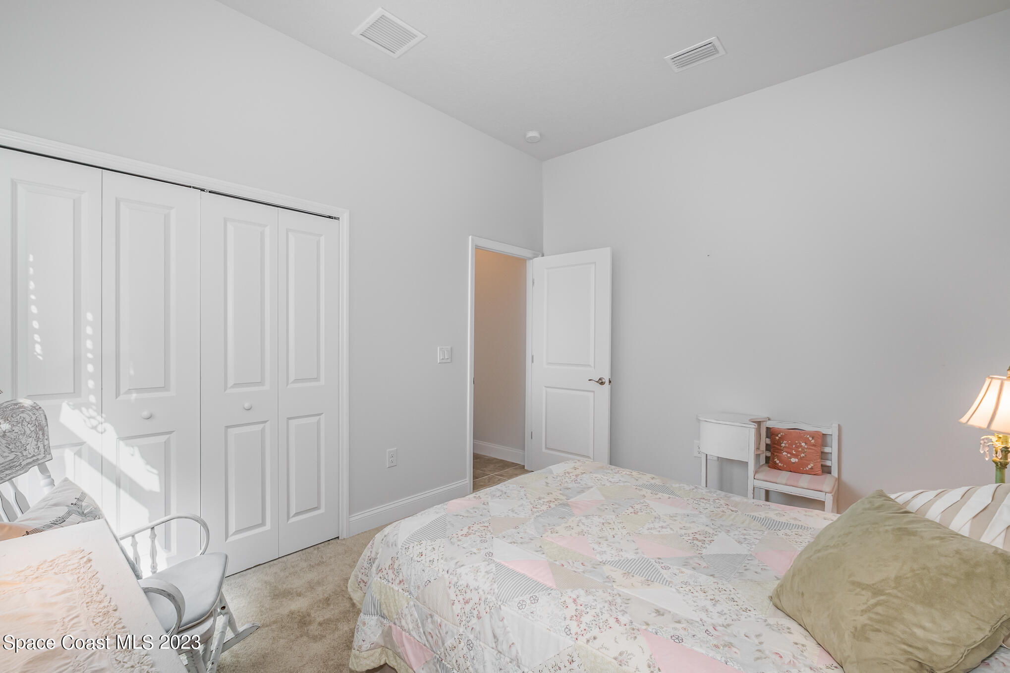 665 Lorelei Avenue Melbourne, FL 32901 - Photo 30 of 32 a bedroom with a bed and a cabinets