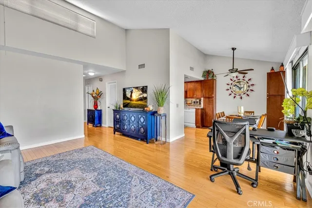 a kitchen with stainless steel appliances granite countertop a dining table and chairs