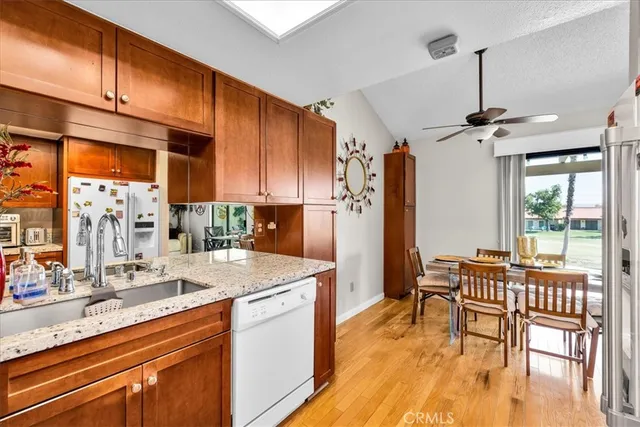 a view of living room with granite countertop kitchen island and stainless steel appliances