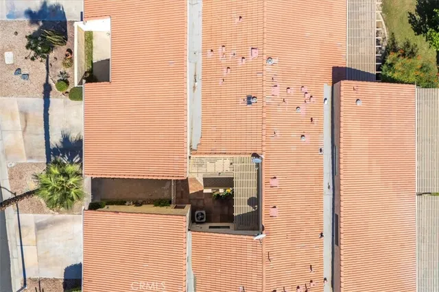 an aerial view of a houses with a swimming pool