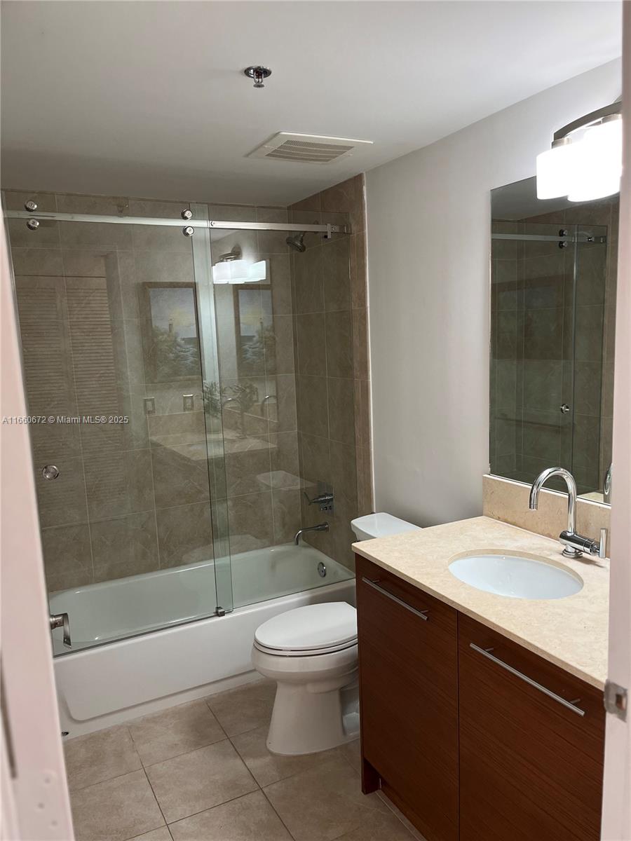 2681 North Flamingo Road, Unit 2108S Sunrise, FL 33323 - Photo 12 of 20 a bathroom with a sink a toilet and shower