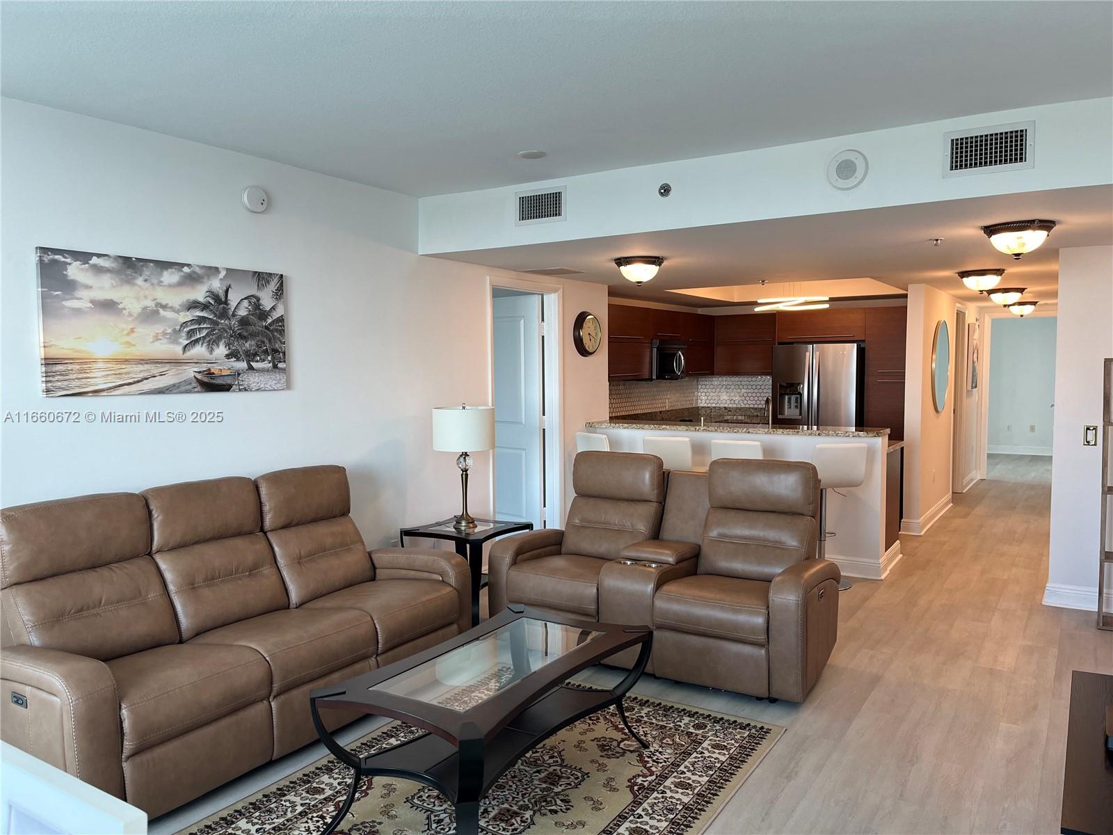 2681 North Flamingo Road, Unit 2108S Sunrise, FL 33323 - Photo 4 of 20 a living room with furniture and a view of kitchen