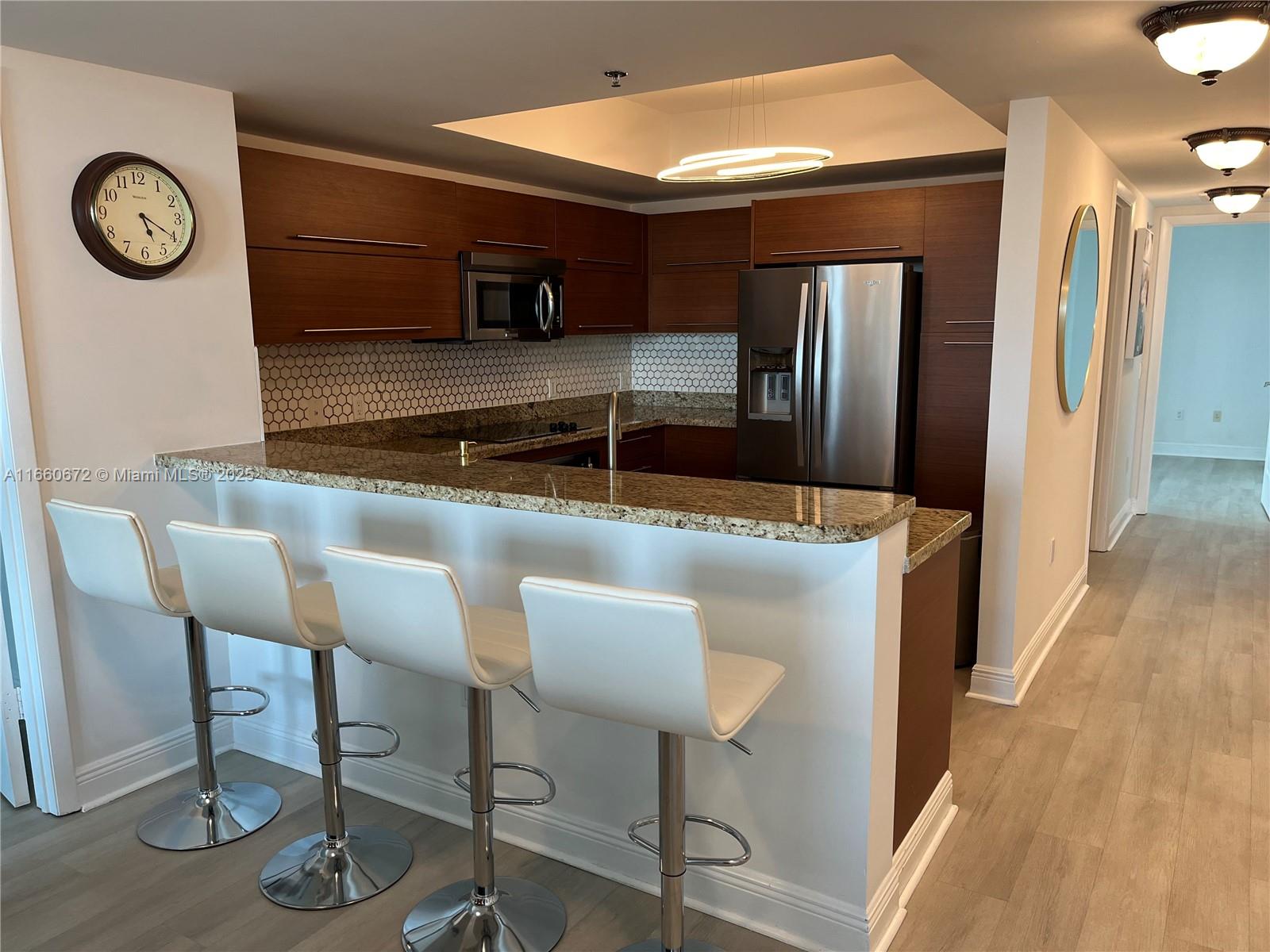 2681 North Flamingo Road, Unit 2108S Sunrise, FL 33323 - Photo 6 of 20 a kitchen with a table and chairs