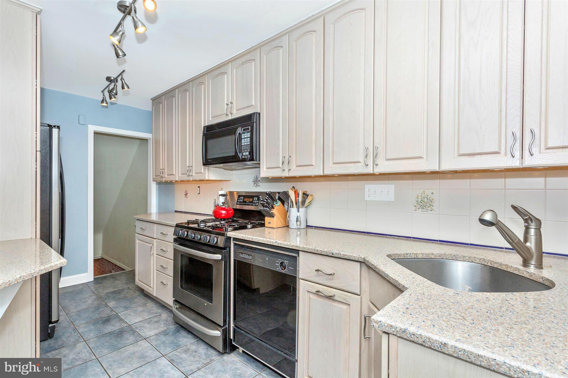 172 Stanmore Road Baltimore, MD 21212 - Photo 12 of 30 a kitchen with stainless steel appliances granite countertop a sink dishwasher stove and refrigerator