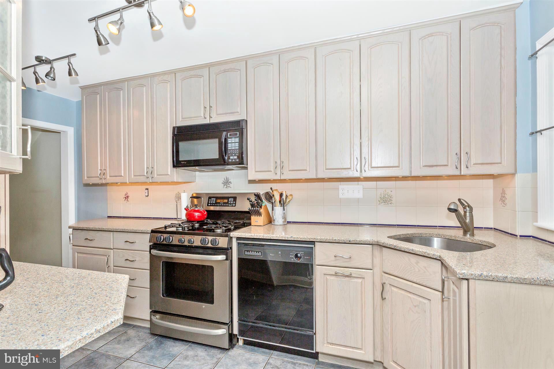 172 Stanmore Road Baltimore, MD 21212 - Photo 14 of 30 a kitchen with white cabinets and white appliances