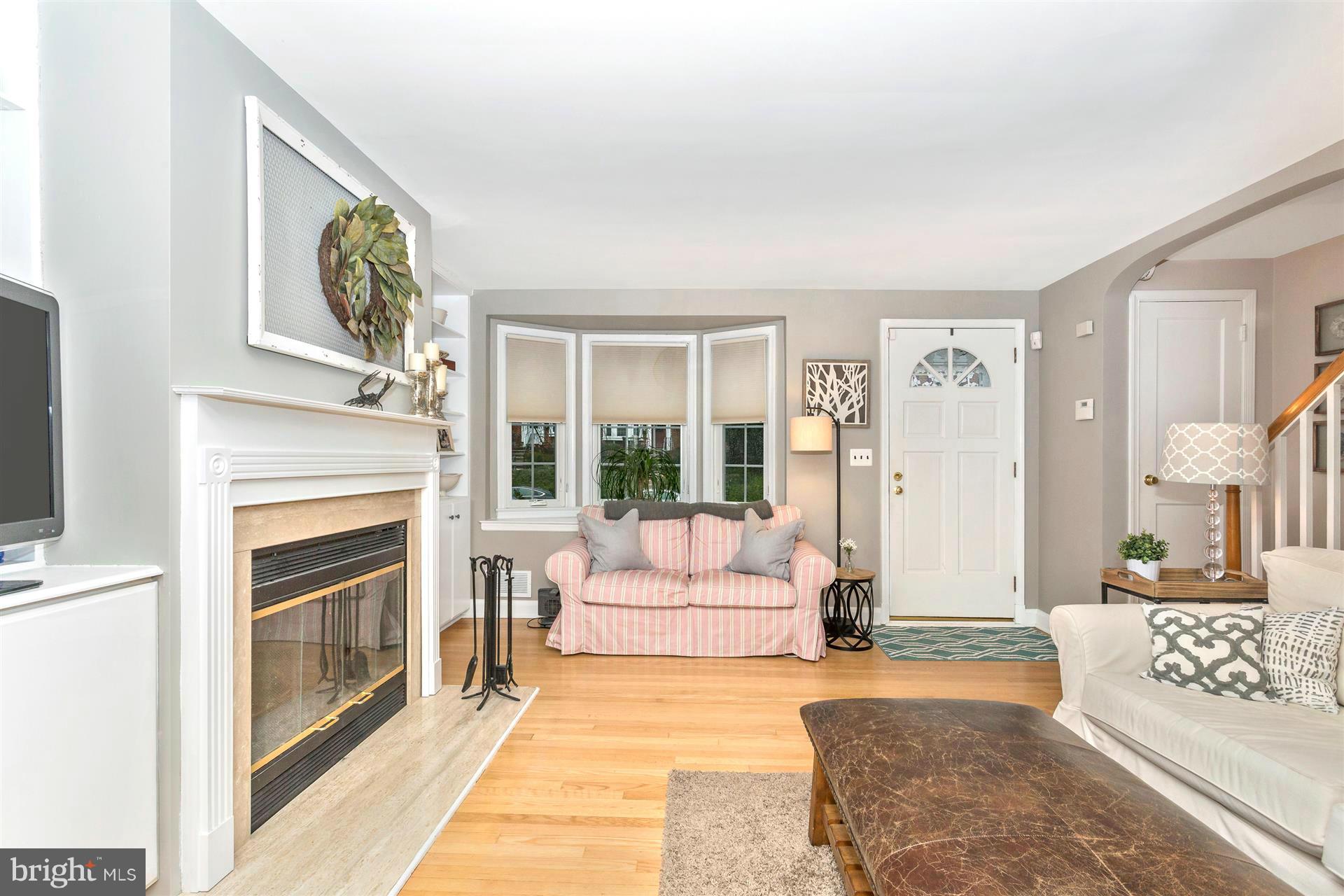 172 Stanmore Road Baltimore, MD 21212 - Photo 5 of 30 a living room with furniture a fireplace and a flat screen tv