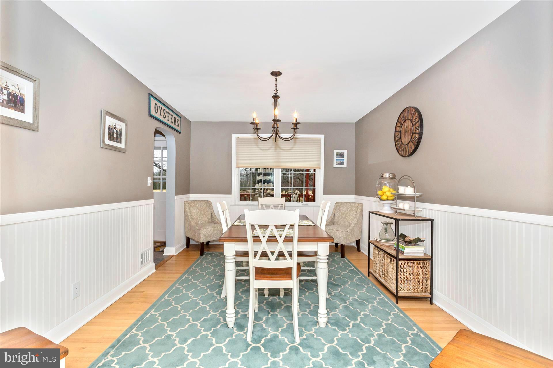 172 Stanmore Road Baltimore, MD 21212 - Photo 10 of 30 a dining room with furniture a rug and a chandelier