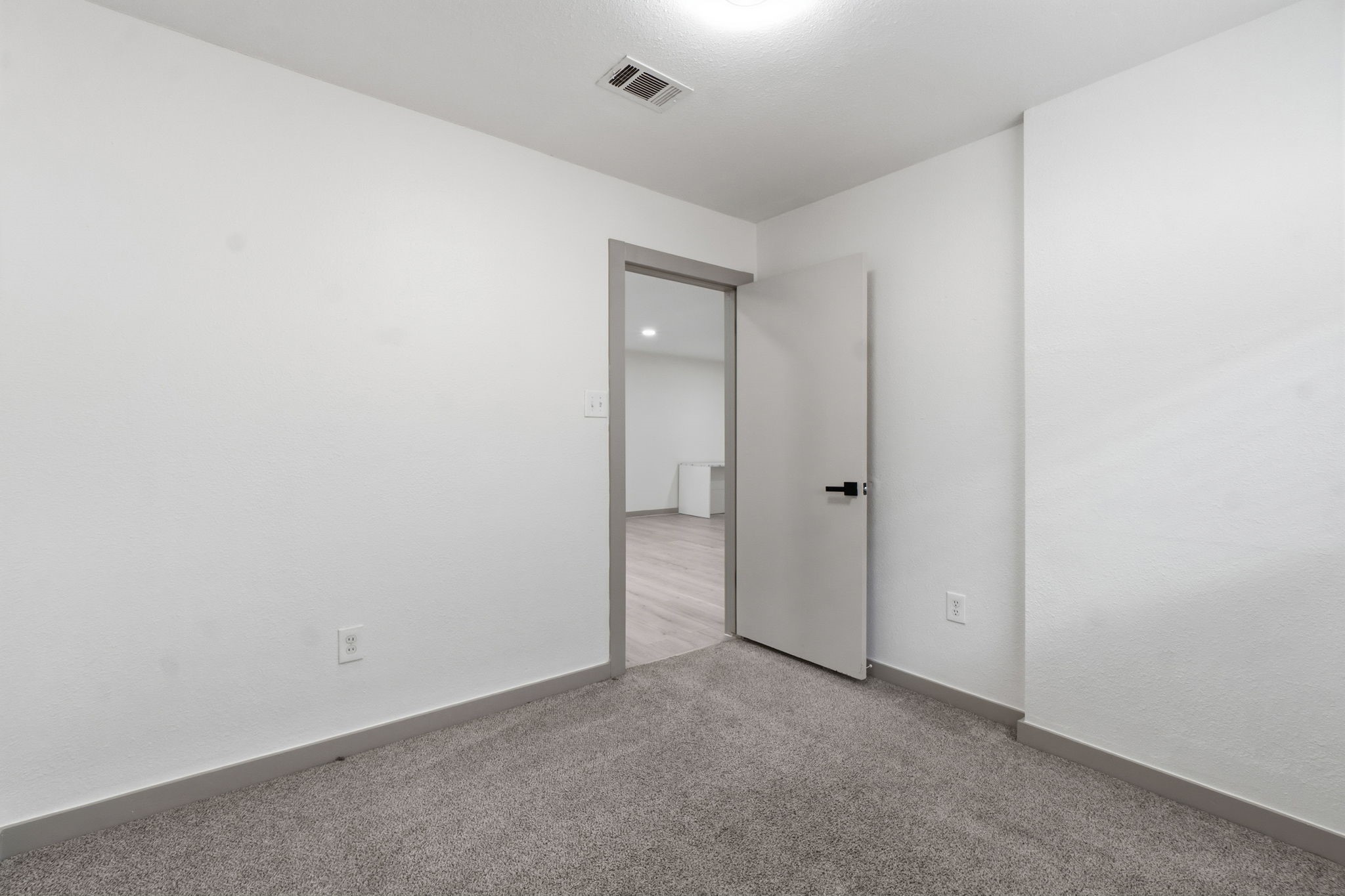14850 Coaltown Road Willis, TX 77378 - Photo 20 of 41 Additional bedroom with plush carpeting, neutral paint palette, and natural lighting ideal for family, guests, or office space.