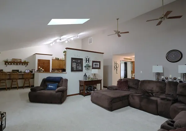 a living room with furniture a couch and a large window