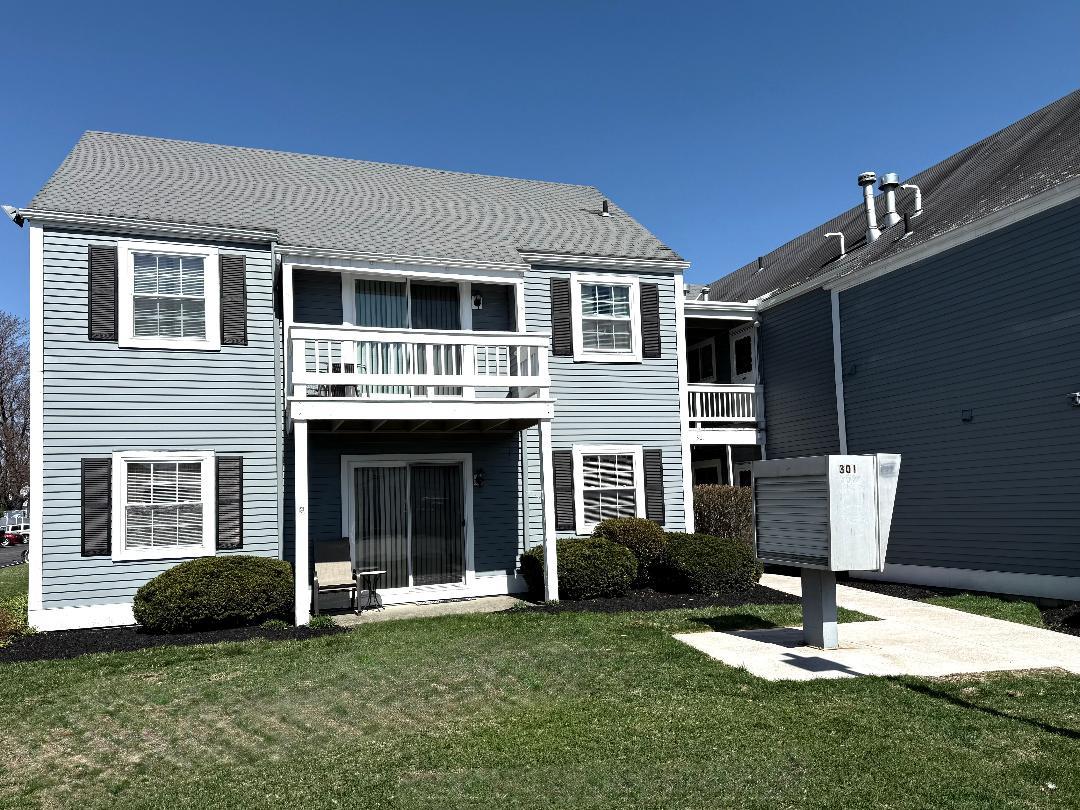 301 Commons Way, Unit B Fishkill, NY 12524 - Photo 1 of 1 Rear view of property featuring a lawn and a shingled roof