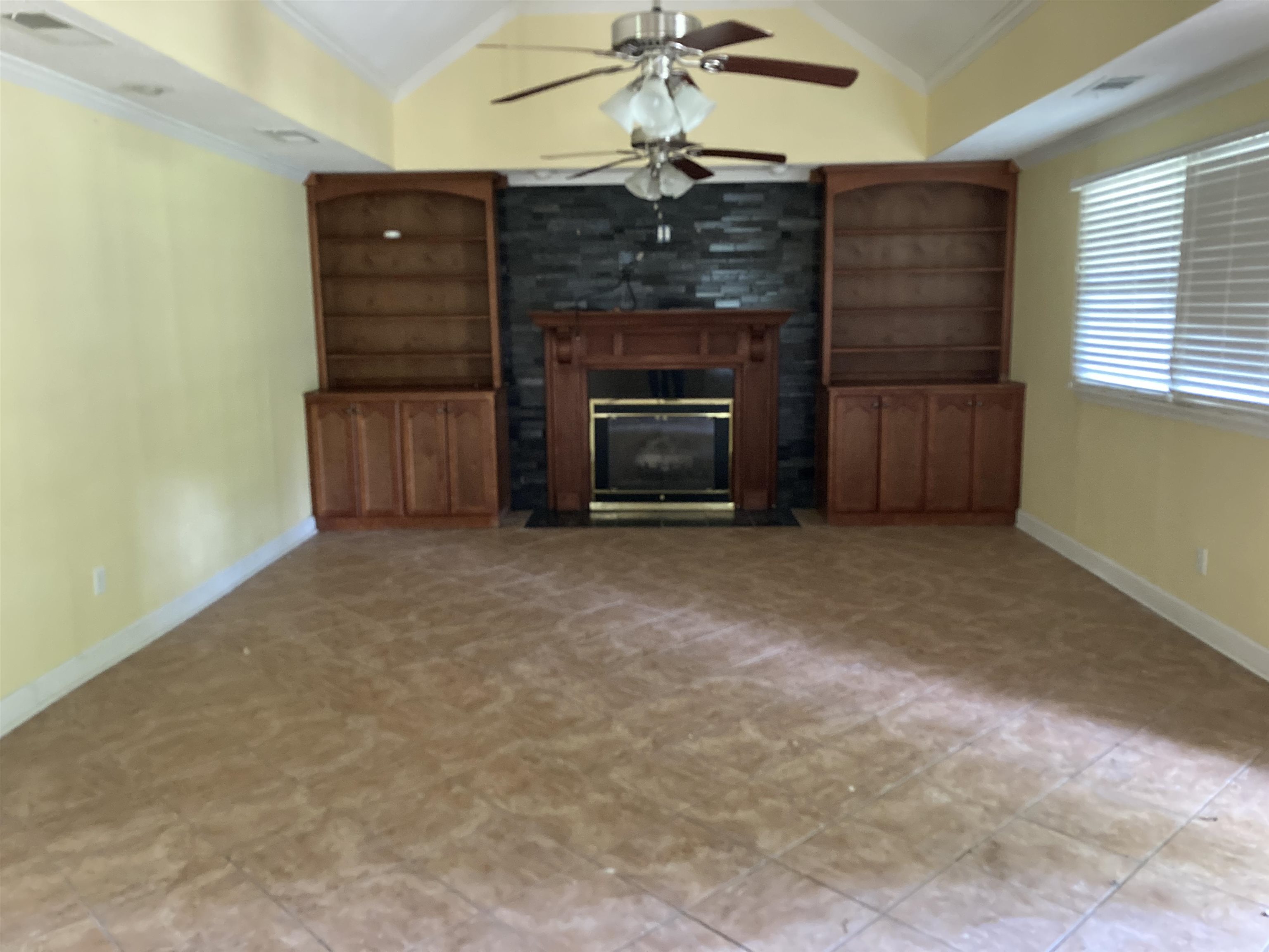 6403 Patmore Road Memphis, TN 38134 - Photo 3 of 8 a view of an empty room with a fireplace and window