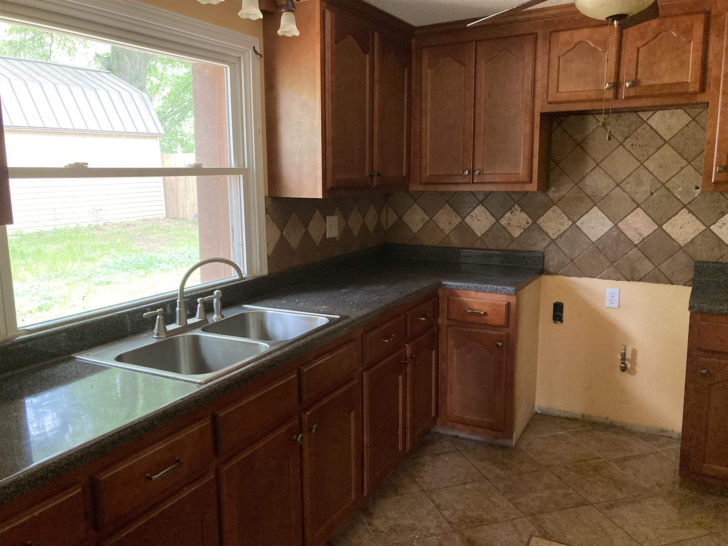 6403 Patmore Road Memphis, TN 38134 - Photo 4 of 8 a kitchen with a sink and a window