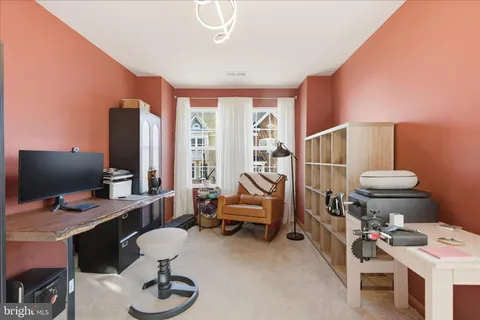 a bedroom with furniture and a large window