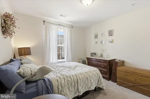 a bedroom with a bed and a desk