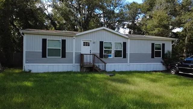 a front view of a house with a yard and porch