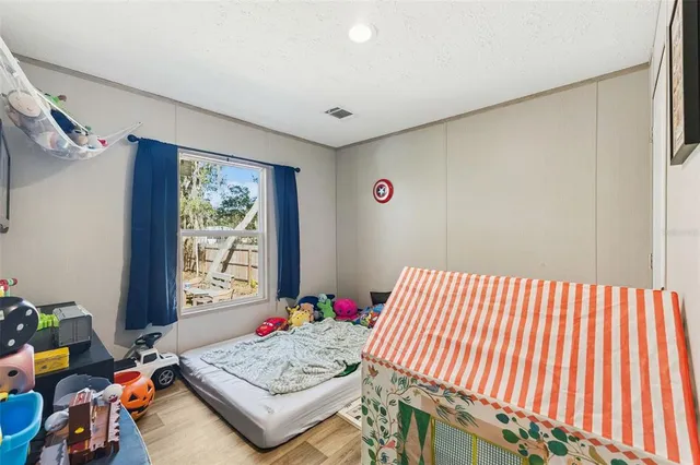 a bedroom with furniture and a window