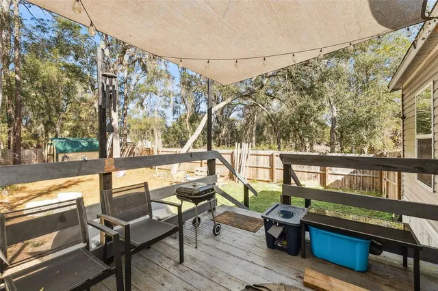 a view of a balcony with chairs and wooden floor