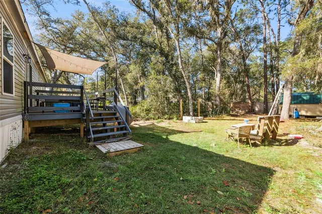 a backyard of a house with outdoor seating