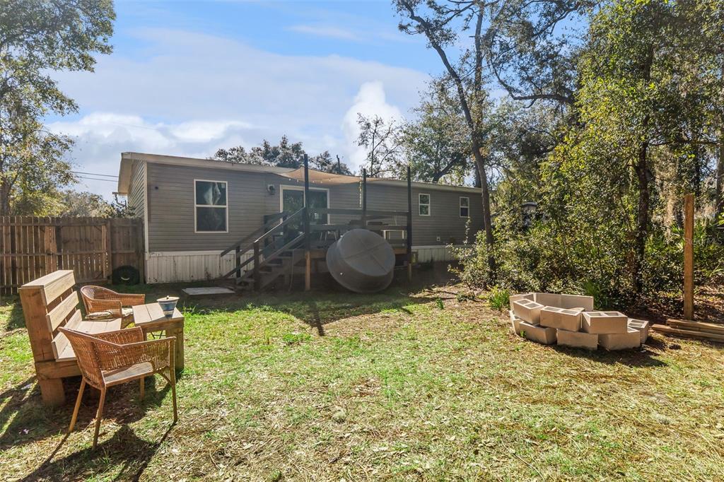 231 Tropic Avenue Satsuma, FL 32189 - Photo 19 of 28 a backyard of a house with outdoor seating