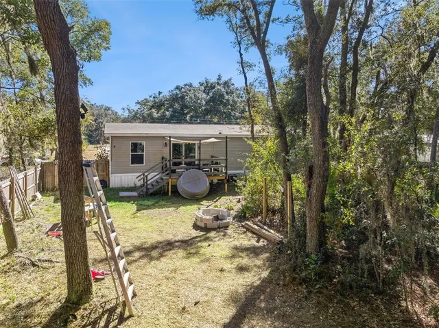 a swimming pool with barbeque and outdoor seating