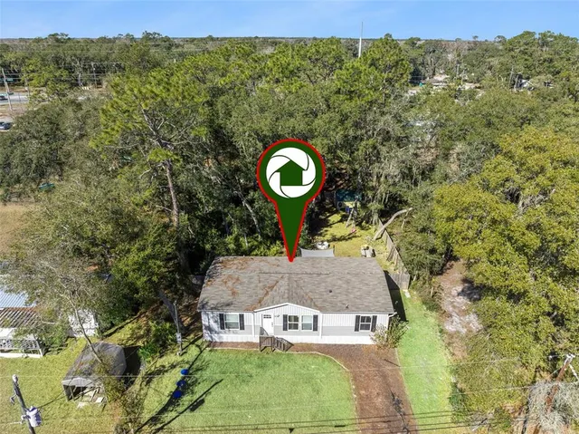 front view of a house with a tree