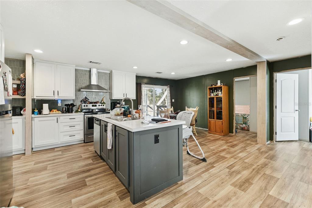 231 Tropic Avenue Satsuma, FL 32189 - Photo 6 of 28 a kitchen with a sink stove and cabinets