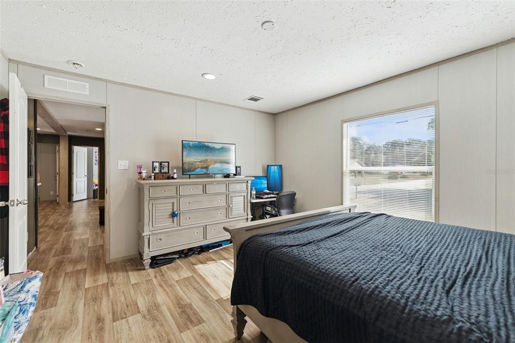 231 Tropic Avenue Satsuma, FL 32189 - Photo 9 of 28 a bedroom with a bed and a view of kitchen