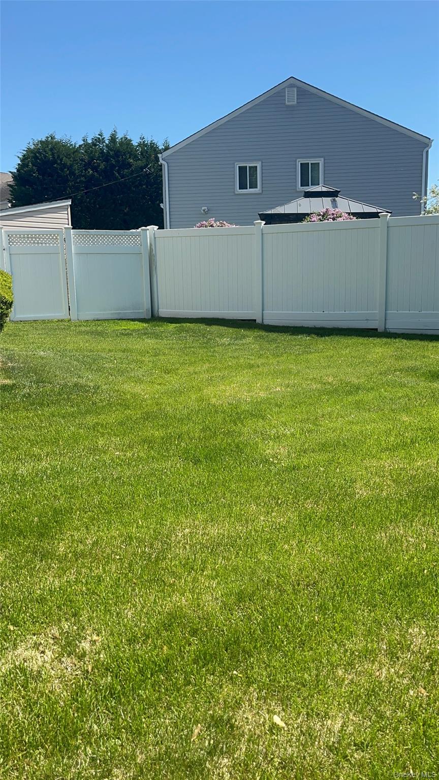 4278 Clarissa Road Bethpage, NY 11714 - Photo 9 of 9 Expansive lawn area featuring well-maintained turf