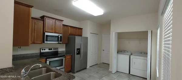 a kitchen with a refrigerator stove and sink