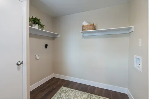 a small space with wooden floor and a window