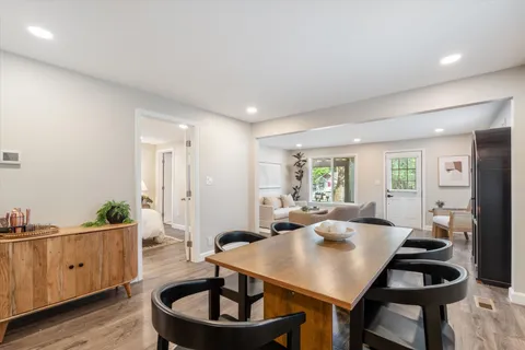 a living room with furniture a wooden floor and sink