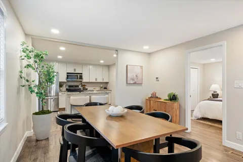 a kitchen with a table and chairs in it
