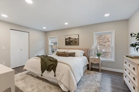 a bedroom with a large bed and a window