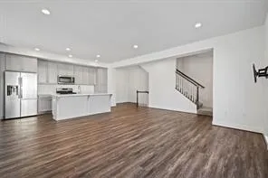 a view of kitchen with wooden floor and electronic appliances